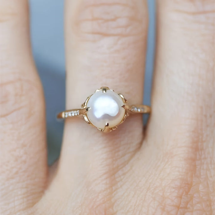 Delicate women's pearl & crystal ring, a stunning fashion accessory. Elegant silver or gold statement jewelry.