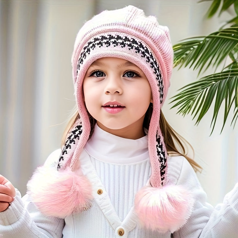 Kids' cozy pink knit winter hat with ear flaps, braided ties, and two fluffy pom-poms for warmth & style.