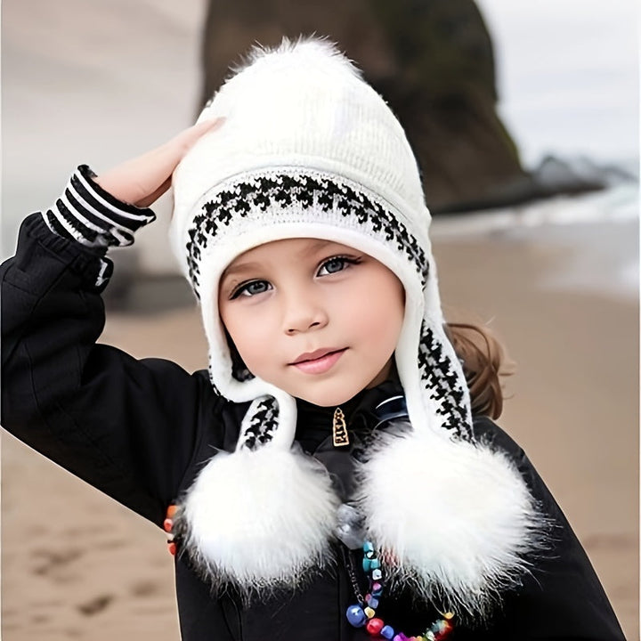 Pink knit toddler winter hat with ear flaps and two white pom-poms, a snug and stylish cold-weather essential.