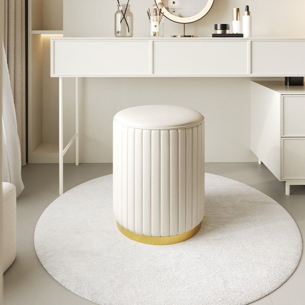 Stylish upholstered round ottoman, mirrored storage for bedroom decor.