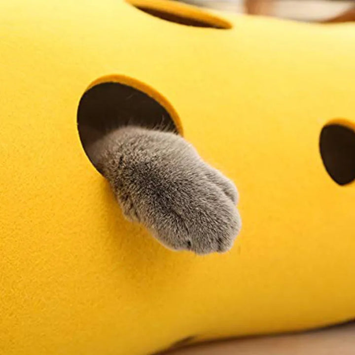 Cat exploring a grey felt play tunnel with multiple peek-a-boo holes, ideal for feline exercise.
