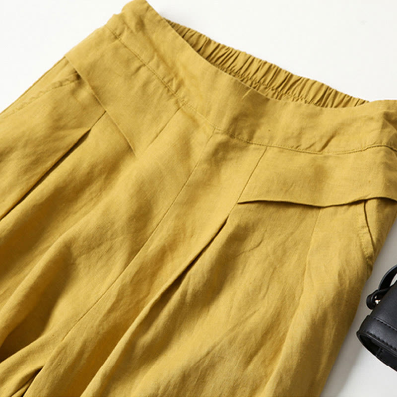 Stylish high-rise wide-leg pleated pants, perfect for business casual fashion.