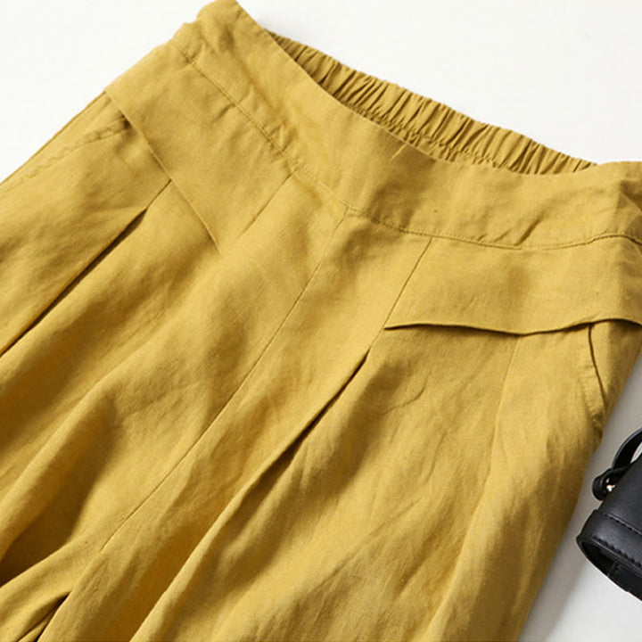 Stylish high-rise wide-leg pleated pants, perfect for business casual fashion.