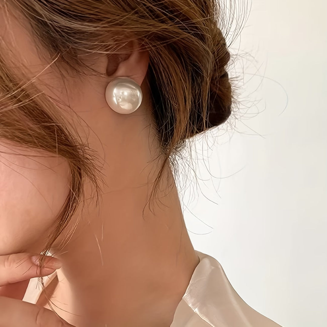 Timeless pearl stud earrings for women, designed as elegant statement jewelry for everyday or special occasions.