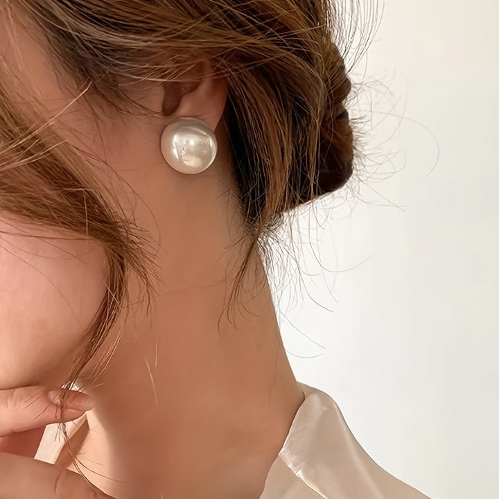 Timeless pearl stud earrings for women, designed as elegant statement jewelry for everyday or special occasions.