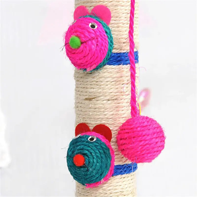 Happy cat playing with a sisal scratcher post with attached toys. Essential pet supply for claw health & furniture protection.