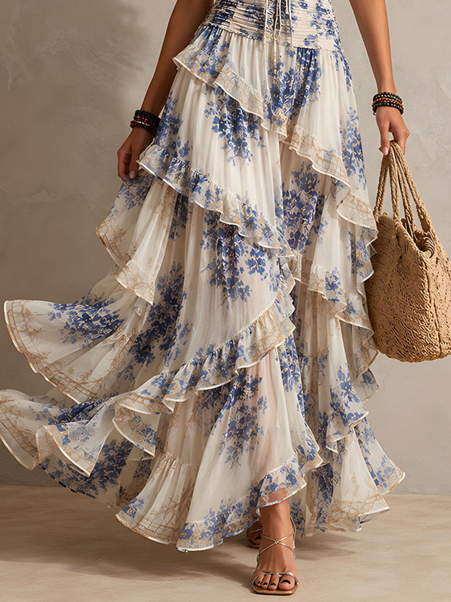 Flowy women's boho blue floral halter maxi dress, featuring elegant tiered ruffles. Comfortable summer resort wear.