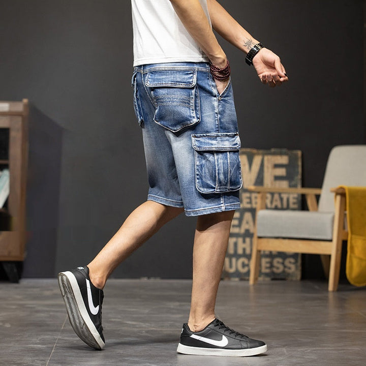 Casual men's light wash cargo shorts featuring practical flap pockets, ideal for versatile summer fashion.