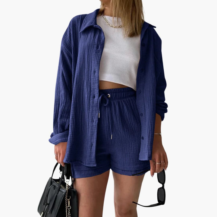 Solid color women's three-piece summer outfit: stylish button shirt, crop top & high-waist shorts. Coordinated.