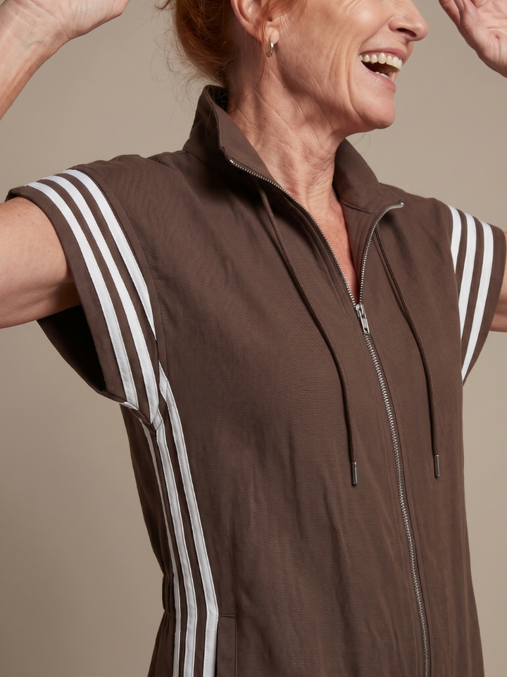 Women's relaxed fit zip front jumpsuit, full length, with modern stripe panel accents.