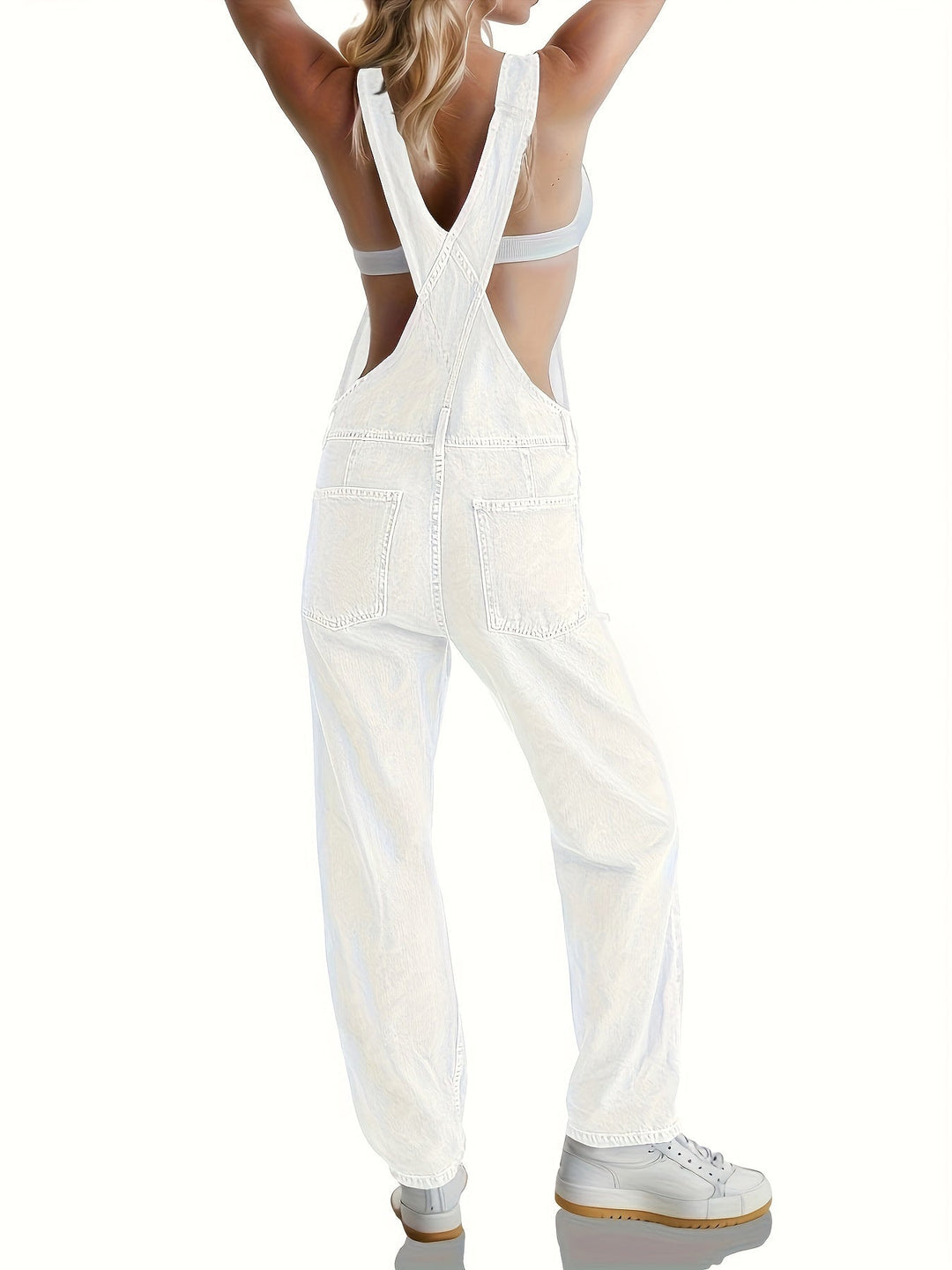 Front pocket detail on casual women's denim dungarees, practical and stylish loose fit overalls.