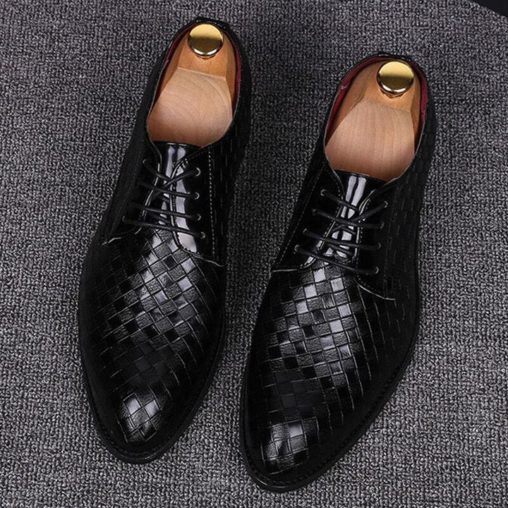 Close-up of elegant men's polished leather lace-up dress shoes, showcasing fine craftsmanship & classic design.
