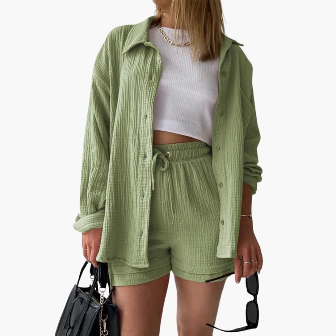 Women's resort wear three-piece outfit: flowy button shirt, crop top & breezy high-waist shorts. Vacation style.