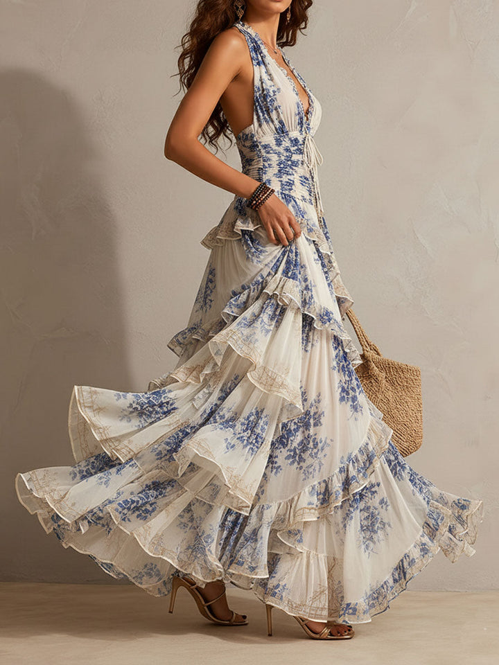 Full-length women's blue floral boho halter maxi dress with flowing tiered ruffles for a chic summer look.