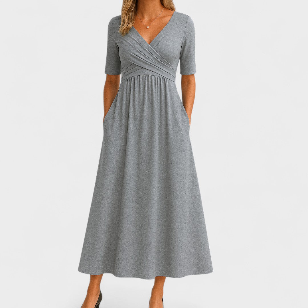 Women's elegant V-neck midi dress with practical pockets, perfect for versatile everyday wear.