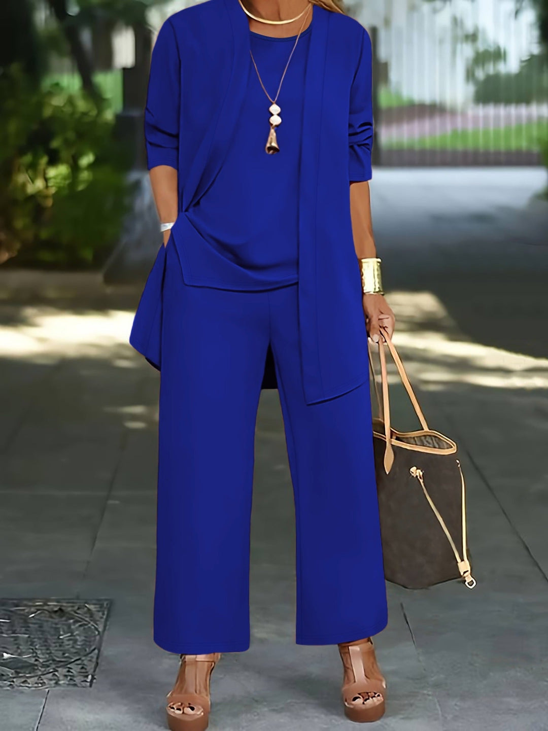Complete women's minimalist 3-piece outfit featuring a vest, blouse & wide-leg trousers for a stylish, modern look.