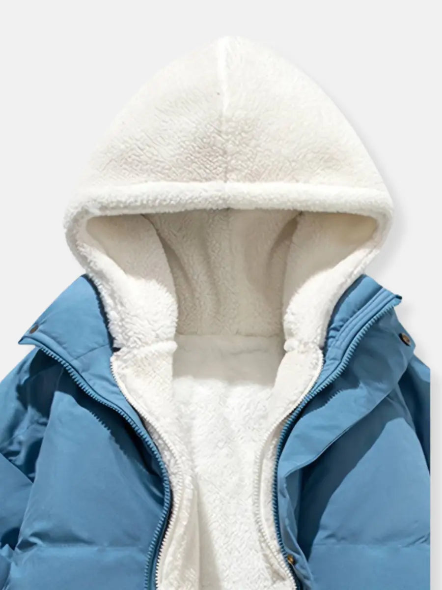 Durable women's puffer jacket with plush-lined hood, perfect for cold weather and travel.