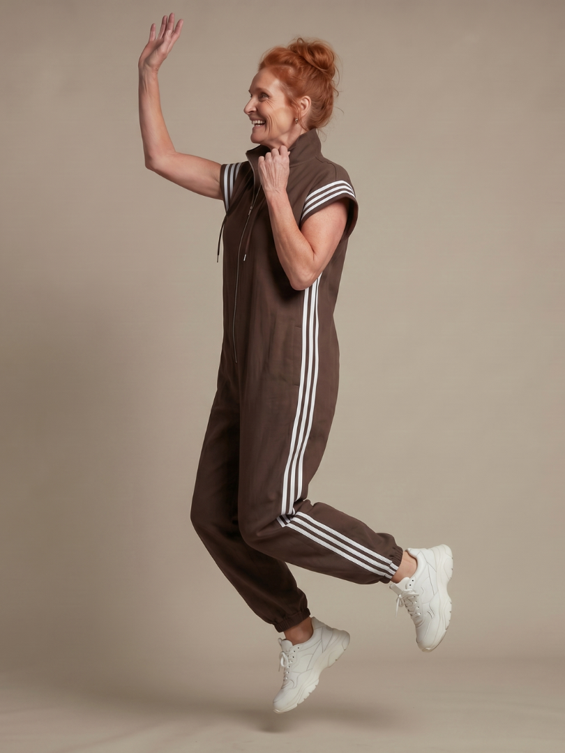 Casual chic women's full-length jumpsuit with a zip front, relaxed fit & distinct stripe panels.