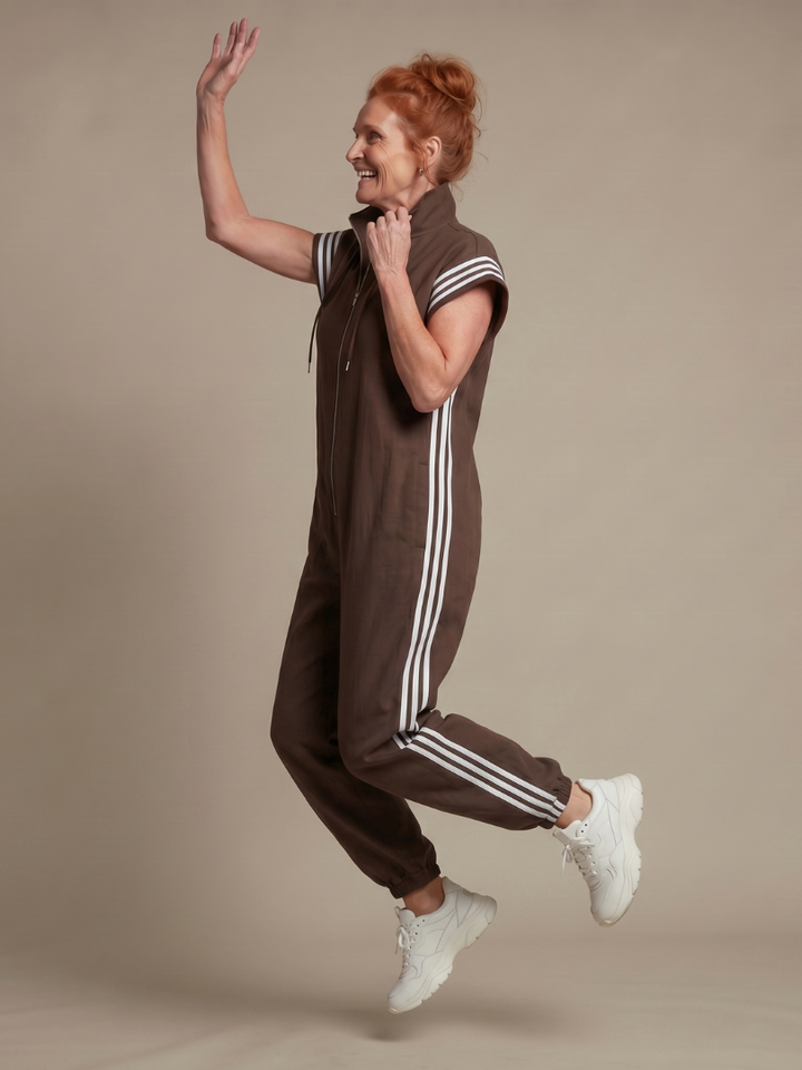 Casual chic women's full-length jumpsuit with a zip front, relaxed fit & distinct stripe panels.