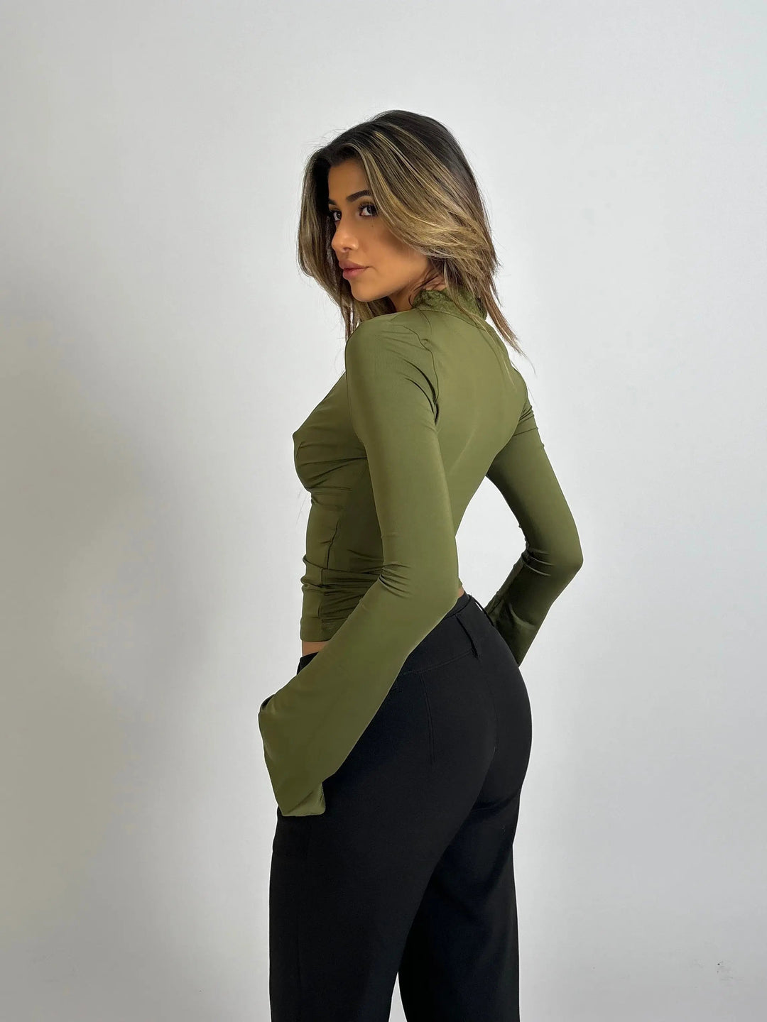 Women's long-sleeve wrap top showcasing a flattering deep V-neckline with exquisite lace trim detail.