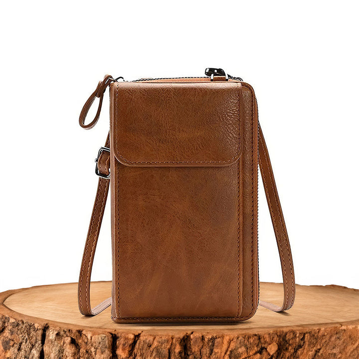 Elegant women's full-grain leather crossbody handbag with minimalist design, perfect for versatile daily use.