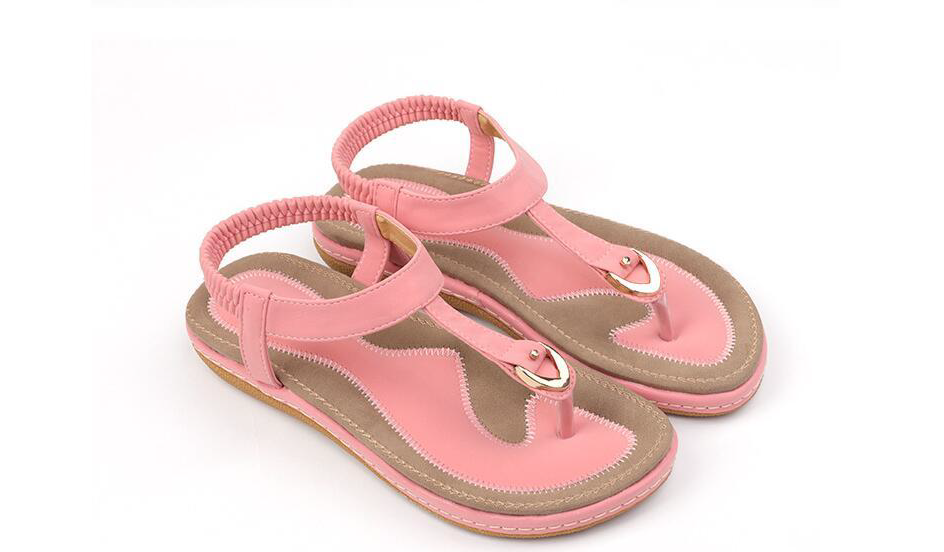Cushioned women's T-strap sandals with elastic ankle strap, offering a comfortable, secure fit for summer.