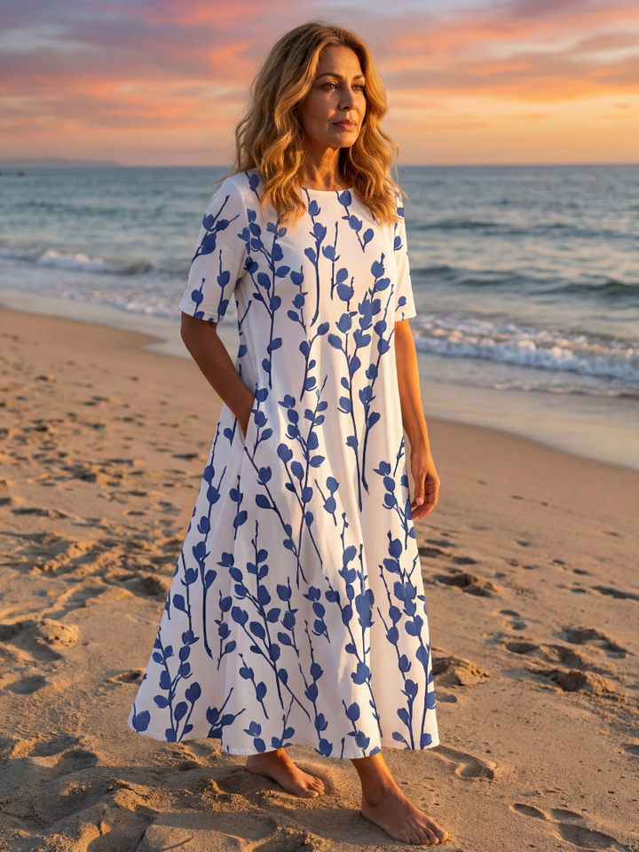 Women's chic floral midi dress with short sleeves & practical pockets, perfect for summer casual wear.