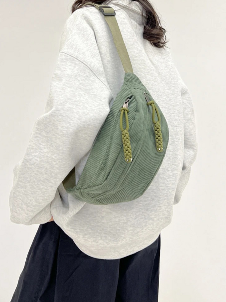 Unisex green corduroy bag, worn as a hip bag. Stylish & versatile for everyday use. Perfect pouch accessory.