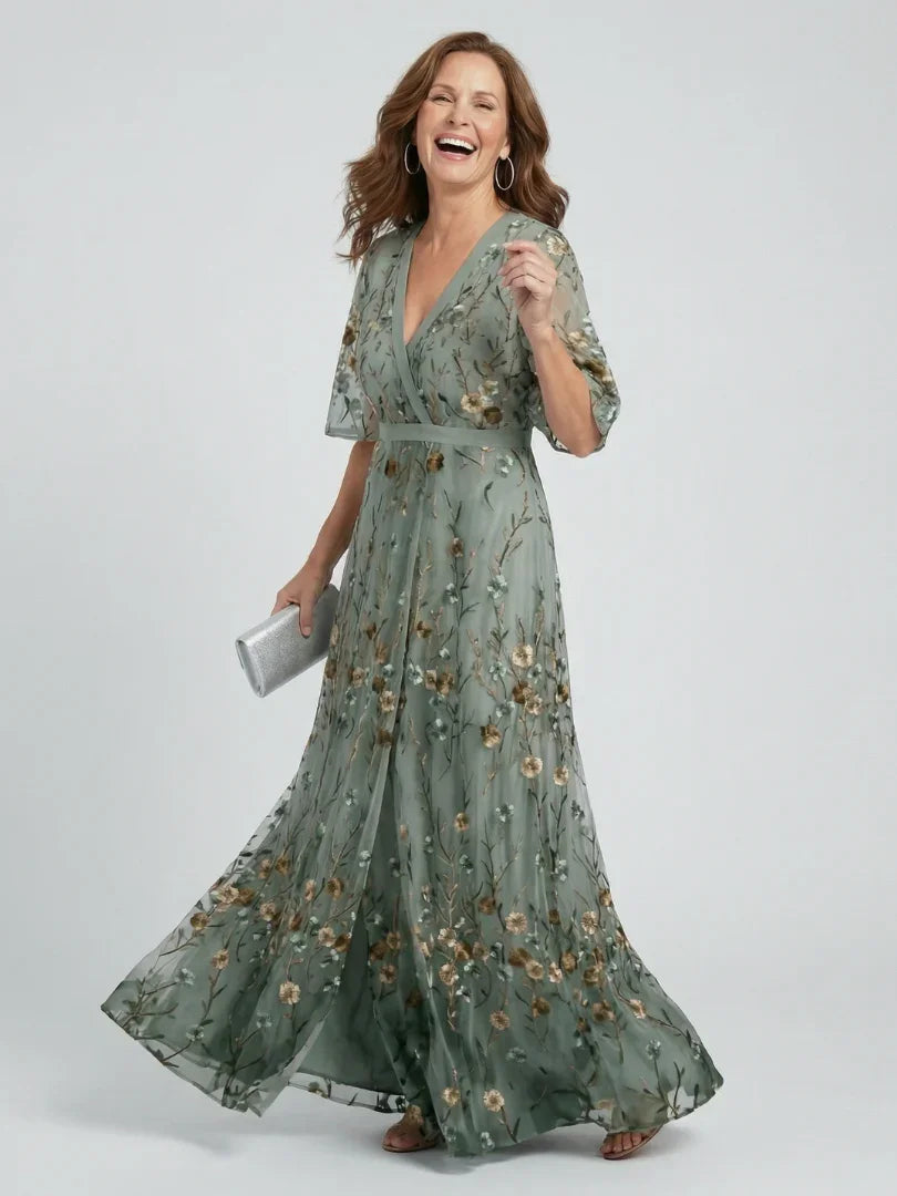 Sage green floral embroidered maxi dress for women, featuring flutter sleeves & drop waist. Perfect for weddings/parties.