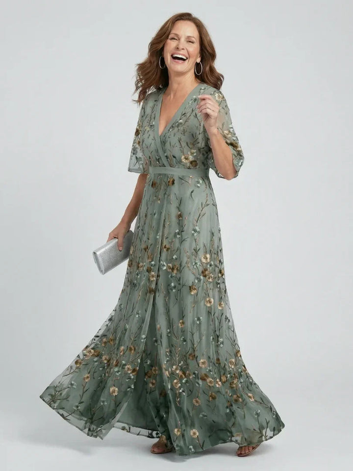 Sage green floral embroidered maxi dress for women, featuring flutter sleeves & drop waist. Perfect for weddings/parties.