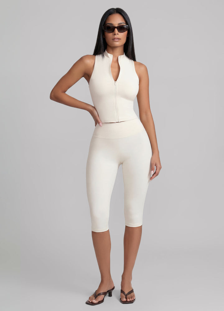 Women's ivory sculpting capri leggings, high-waisted for Pilates & studio workouts. Comfortable & flexible activewear.