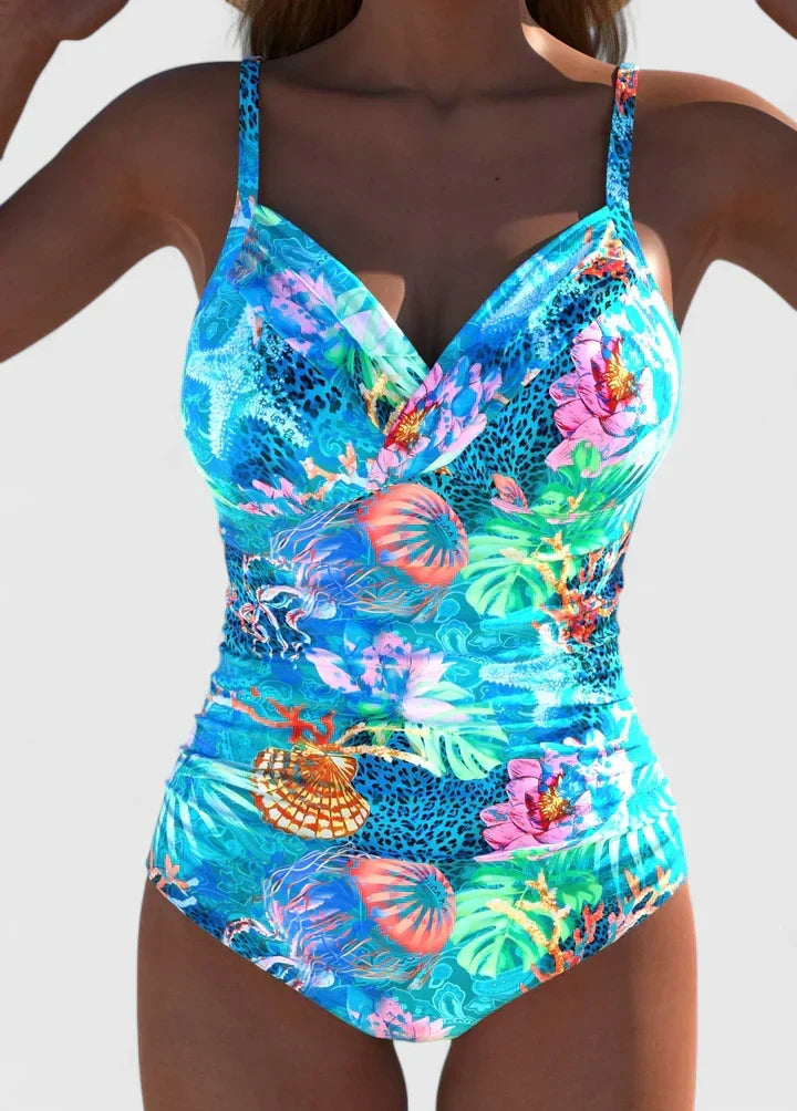 Chic women's printed swimsuit, ideal for poolside style, beach vacations, and summer fashion. Tropical design.