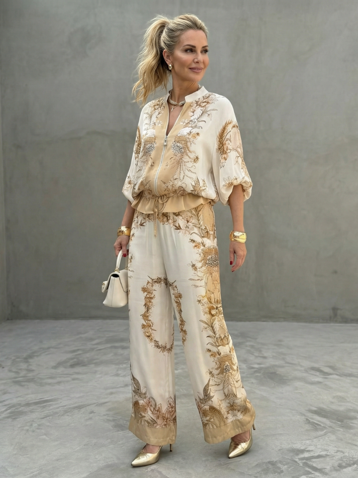 Women's floral two-piece set featuring relaxed fit, wide-leg pants, and elegant satin effect for a stylish look.
