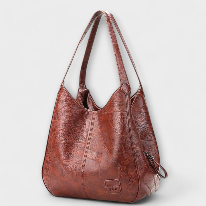 Vintage brown leather shoulder bag for women, elegant and versatile everyday handbag.