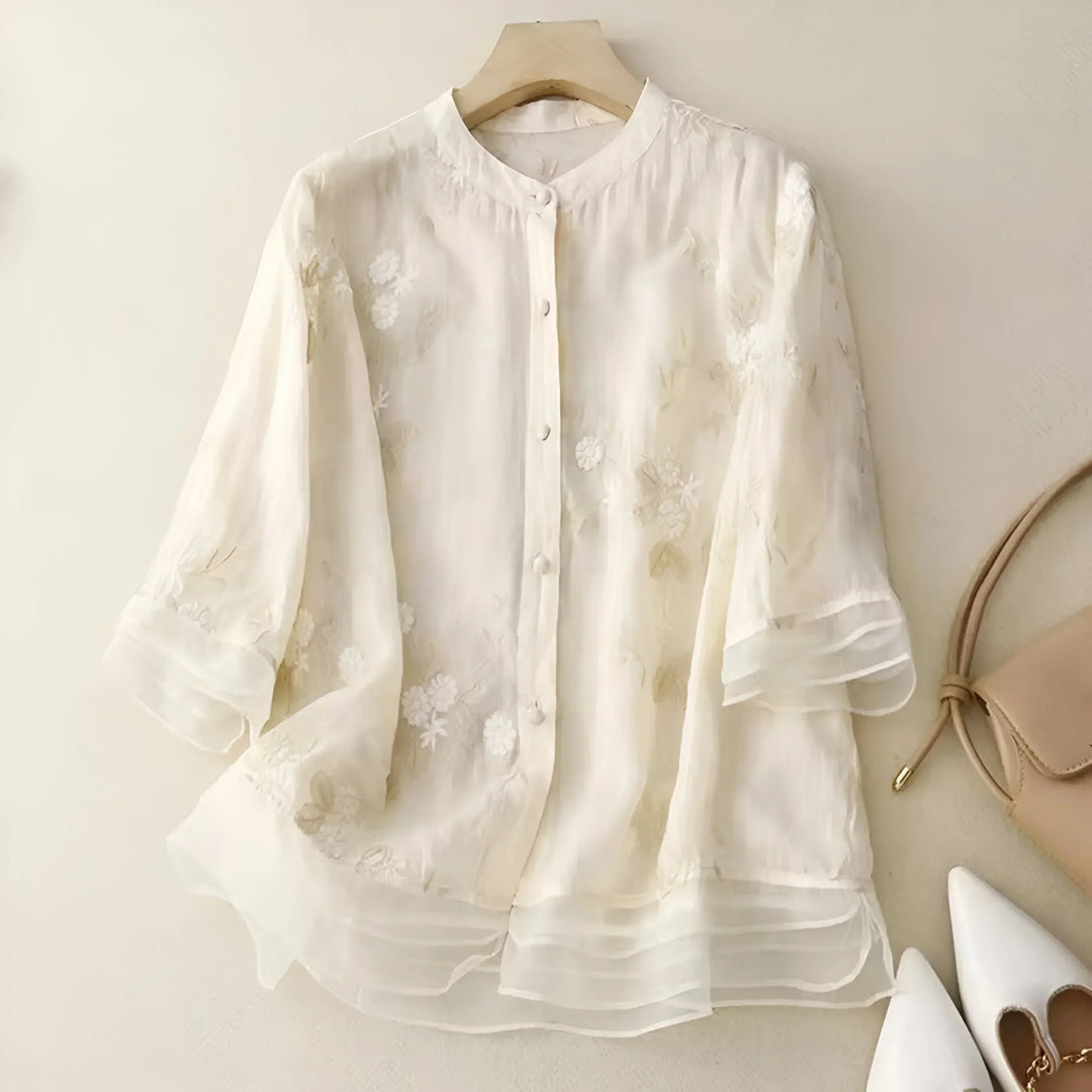 Elegant women's embroidered top with a flattering tummy skimming fit. Perfect for chic everyday wear.