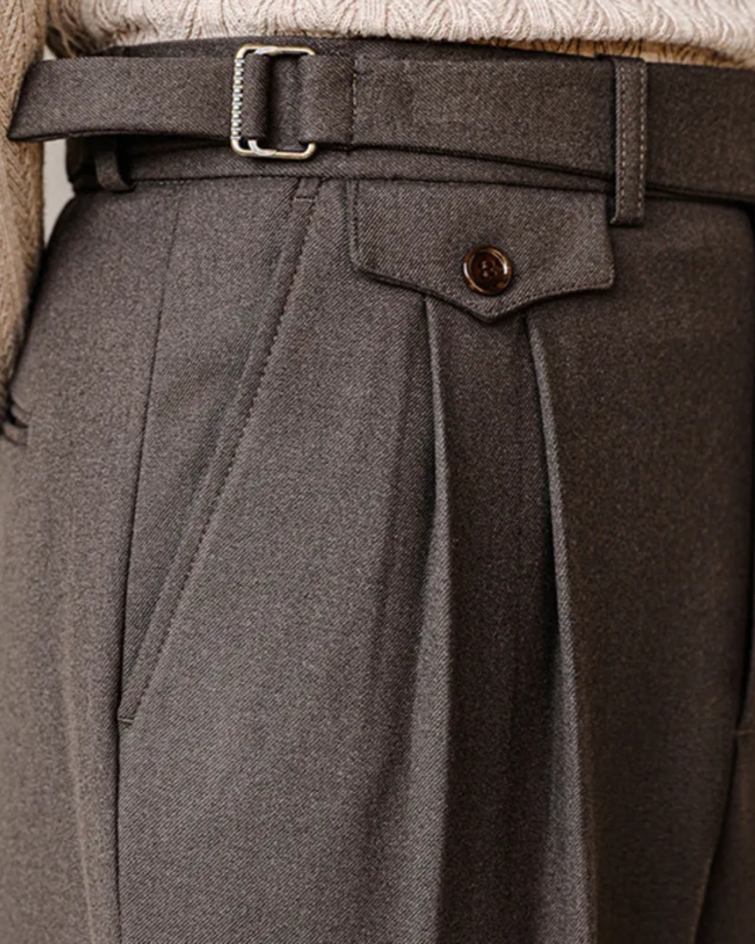 Men's straight fit black pleated trousers. Adjustable waist detail, perfect for smart casual men's fashion.