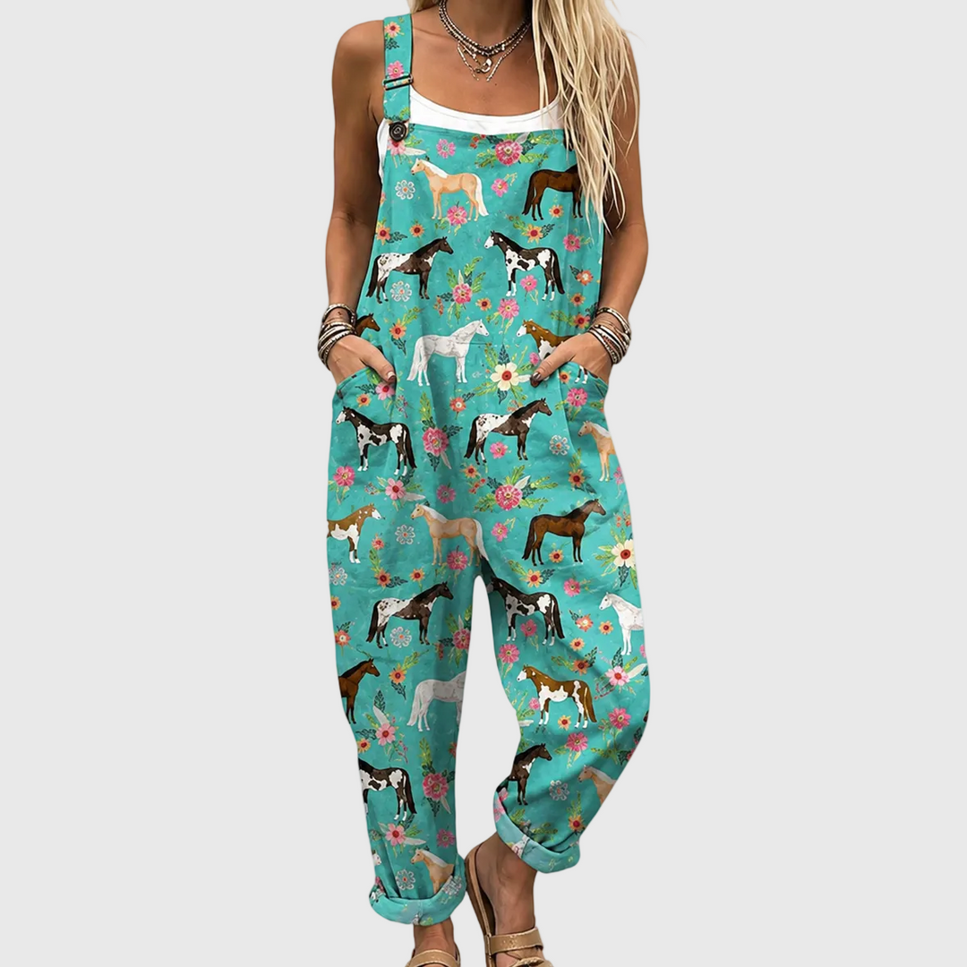 Women's turquoise relaxed fit jumpsuit with floral & horse print, adjustable straps, and pockets for summer.