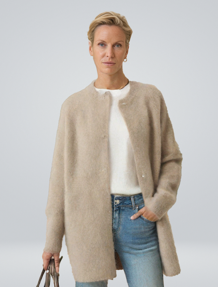 Women's minimalist longline button cardigan, an elegant layering piece for versatile autumn outfits.