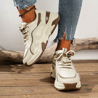 Women's chunky platform sneakers with contrast panels, white laces, and thick sole. Trendy street style casual footwear.