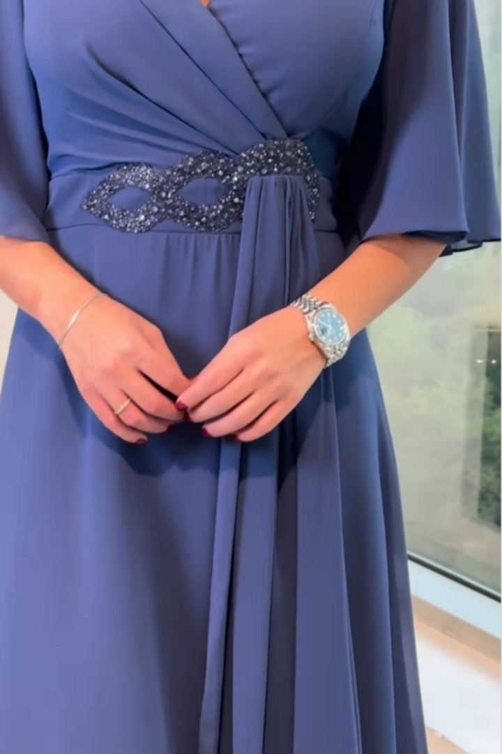 Flowing long V-neck occasion dress for women. Elegant formal wear, perfect as a wedding guest dress.