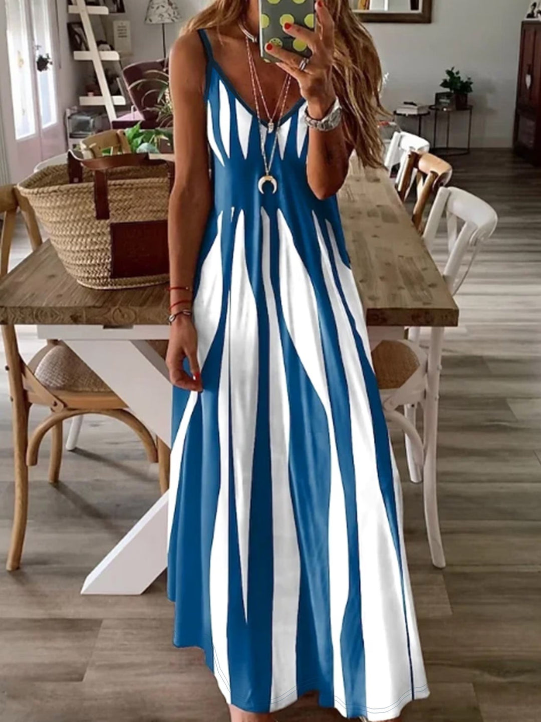 Stylish blue V-neck summer dress for women, featuring thin straps & a comfortable flowing design. Ideal for outings.