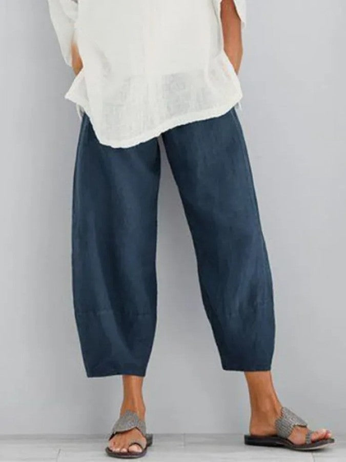 Effortless women's dark blue cropped trousers. Comfortable relaxed fit pants with pockets, ideal for casual style.