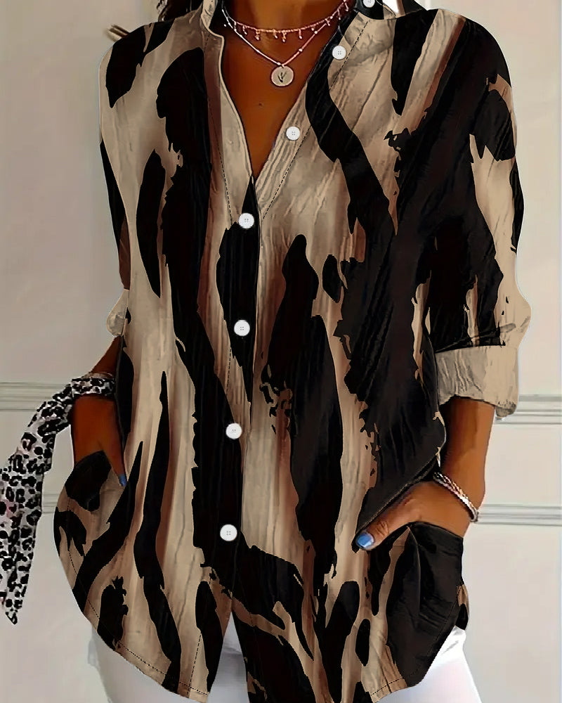 Modern women's stand collar blouse with irregular print, raglan sleeves. Versatile casual fashion top.