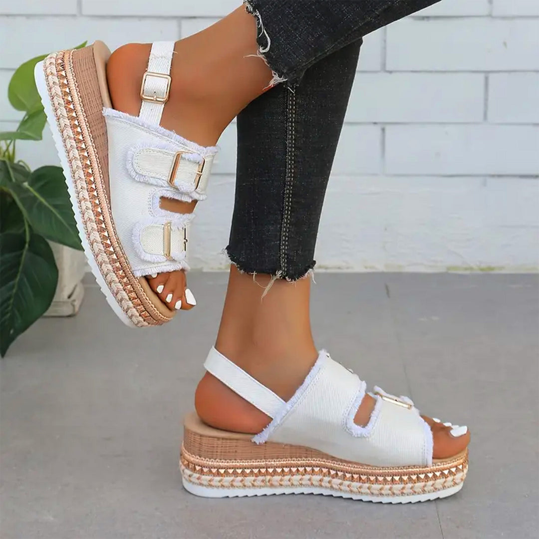 Stylish women's denim wedges, offering comfortable elevated style for casual summer outfits and footwear.