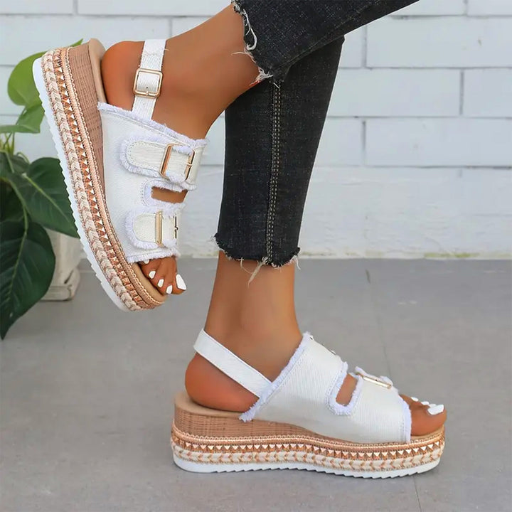 Stylish women's denim wedges, offering comfortable elevated style for casual summer outfits and footwear.