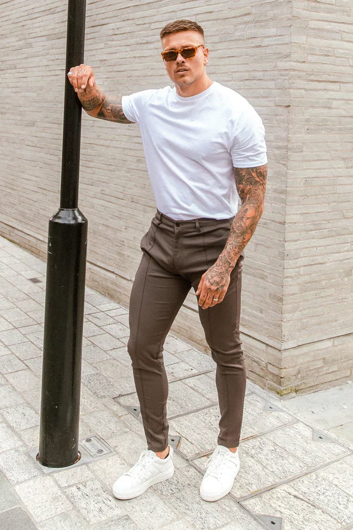 Versatile men's slim-fit chinos in beige, gray, or black, suitable for casual or formal wear.