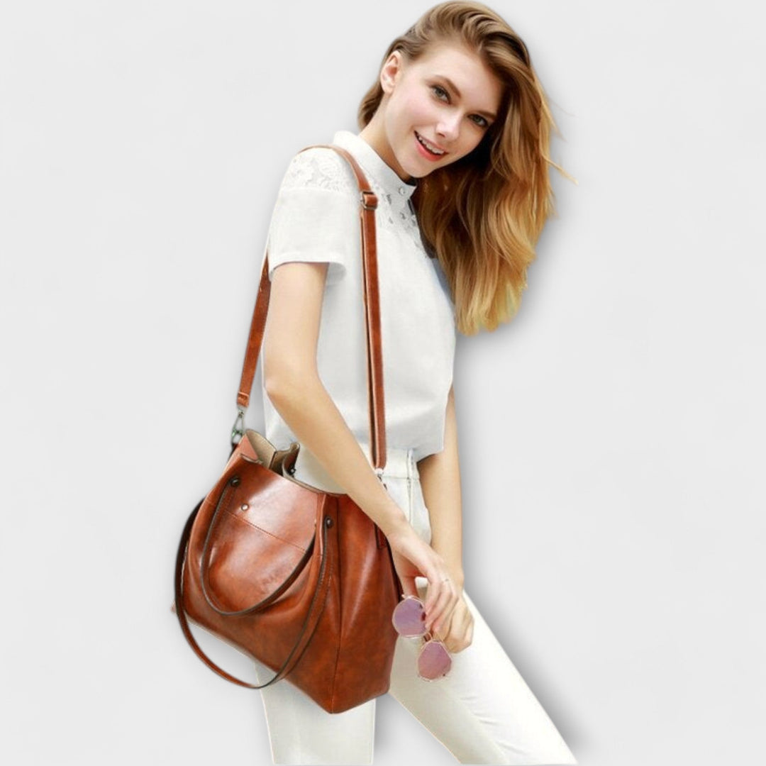 Gray fashionable 4 piece vintage women's handbag set. Complete with tote, purse, and clutch.