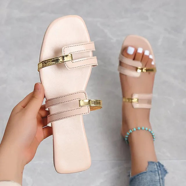 Chic women's flat sandals: comfortable open-toe slides with trendy double straps & gold accents.