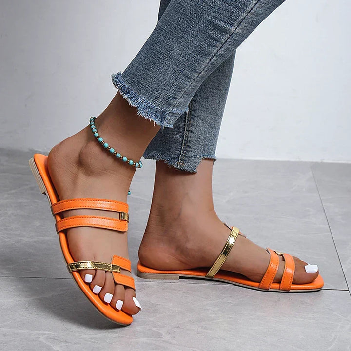 Women's chic flat sandals with gold-detail double straps, perfect for summer casual wear.