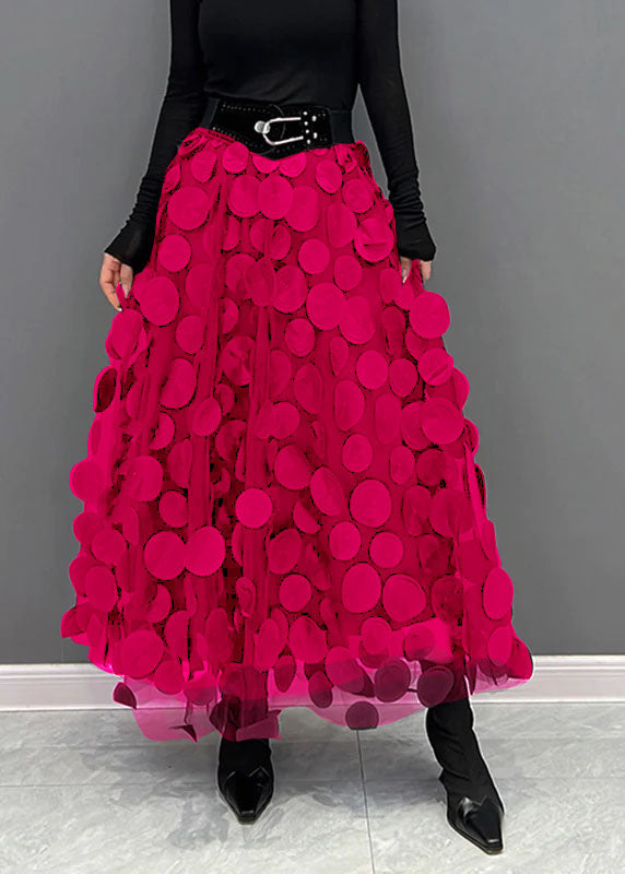 Back view of model in an elegant women's polka dot patchwork maxi skirt, showcasing the long design.